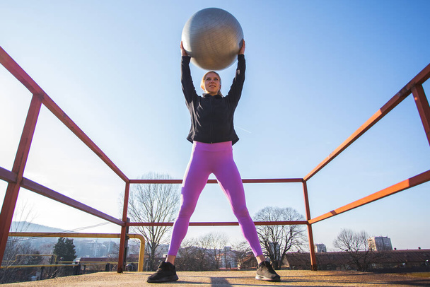 fit young woman doing pilates workout outdoors - Fotoğraf, Görsel