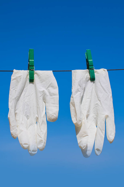 protective gloves dried on sunlight after washing and disinfection - Foto, afbeelding