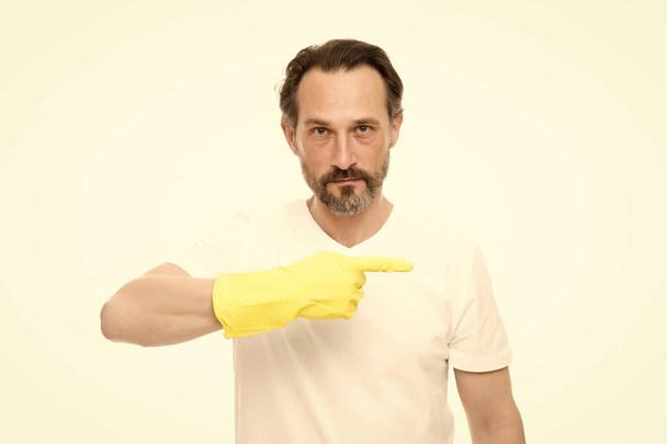 This way. Antibacterial cleaner. Bearded guy cleaning home. Bearded worker. On guard of cleanliness. Cleaning service and household duty. Man use gloves. Cleaning day today. Hygienic requirements - Foto, Bild