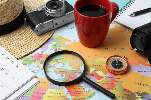 Different travel accessories on world map, closeup. Planning summer vacation trip - Φωτογραφία, εικόνα