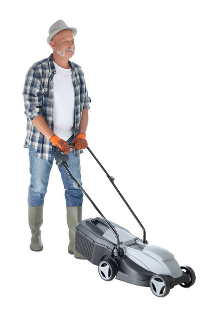 Senior man with modern lawn mower on white background - Фото, зображення