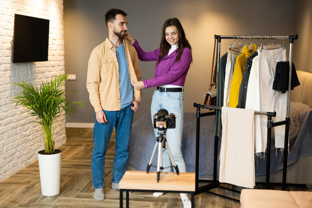 Two bloggers influencers are showing clothes for their followers to sell it on store online indoor. Work indoor on social media - Φωτογραφία, εικόνα