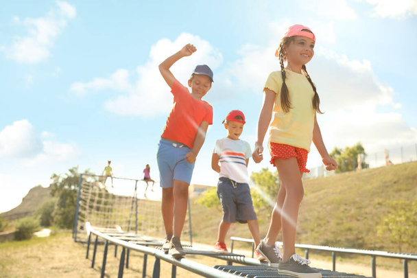 Dışarıda oyun parkındaki sevimli çocuklar tırmanıyor. Yaz kampı - Fotoğraf, Görsel