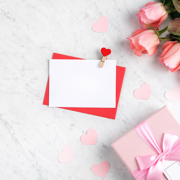 Valentine's Day design concept background with pink rose flower and gift box on marble white background - Foto, afbeelding