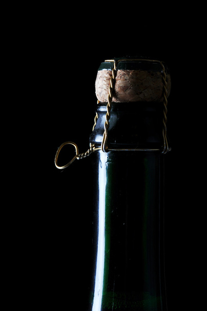 Chilled bottle of champagne on black - Foto, Imagen