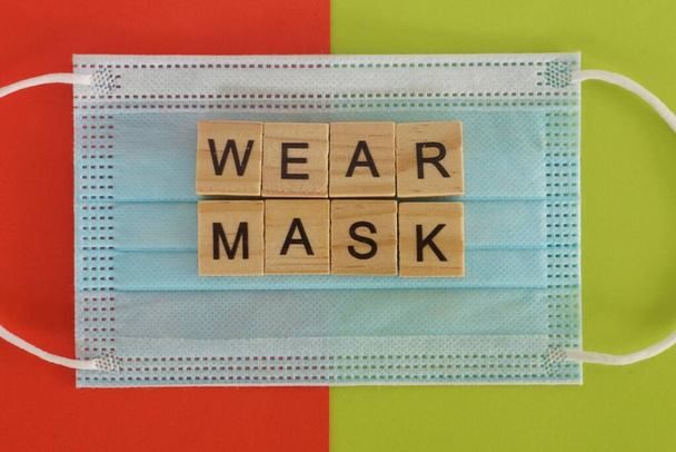 face mask on color background - Фото, изображение
