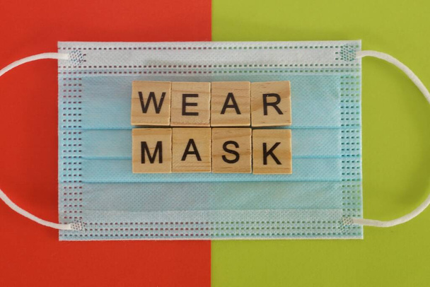 face mask on color background - Фото, изображение