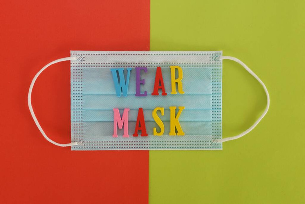 face mask on color background - Photo, Image