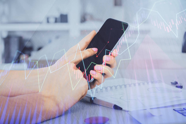 Double exposure of mans hands holding and using a digital device and forex graph drawing. Financial market concept. - Foto, Imagen