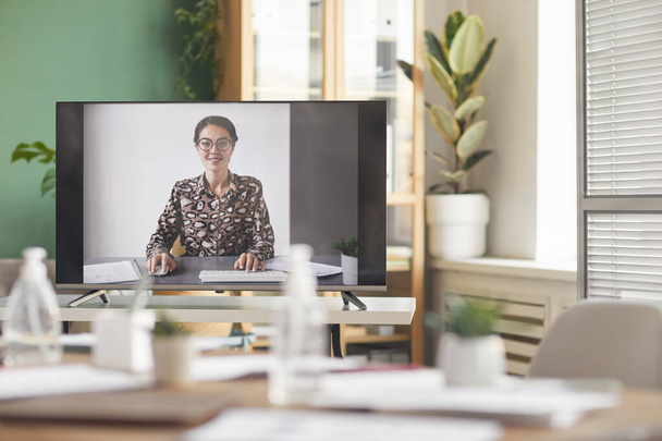 Achtergrondbeeld van lachende zakenvrouw op computerscherm tijdens online zakelijke conferentie, kopieerruimte - Foto, afbeelding