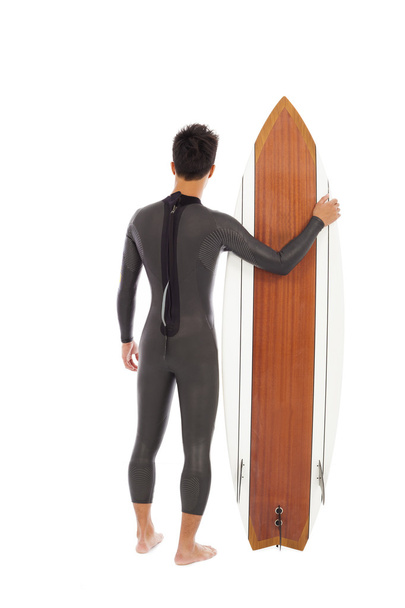 szörfözés férfi viselt nedves ruha és a gazdaság szörfözés board - Fotó, kép