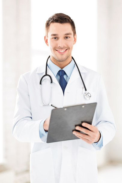 Male doctor writing prescription - Fotó, kép