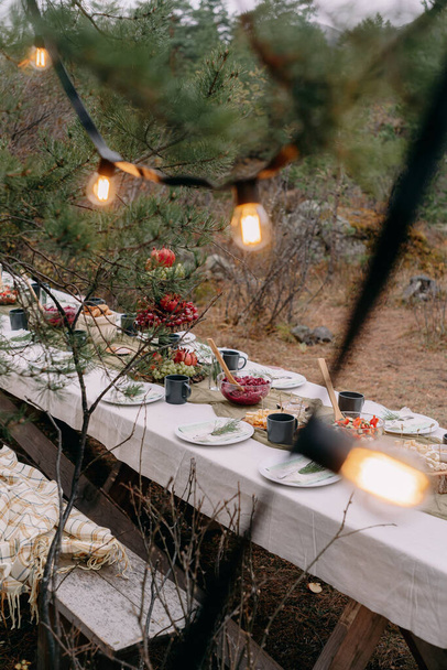 Served wedding table among trees in autumn - Fotó, kép