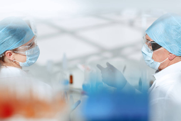 background image of medical colleagues talking in the lab. - Photo, Image