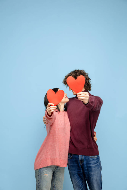 Beautiful couple in love on blue studio background. Valentines Day, love and emotions concept - 写真・画像