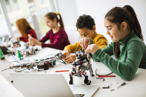 Group of happy kids programming electric toys and robots at robotics classroom - Φωτογραφία, εικόνα