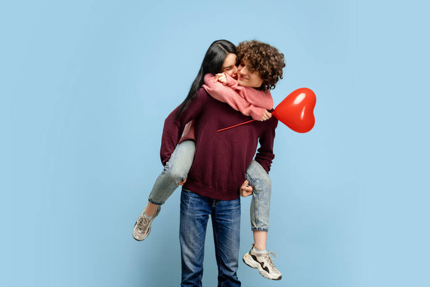 Beautiful couple in love on blue studio background. Valentines Day, love and emotions concept - Fotoğraf, Görsel