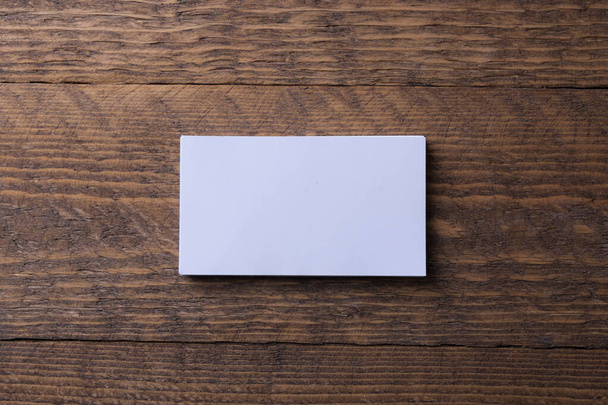 Business card blank on wooden background. Corporate Stationery, Branding Mock-up. Creative designer desk. Flat lay. Copy space for text. Template for ID - Photo, Image