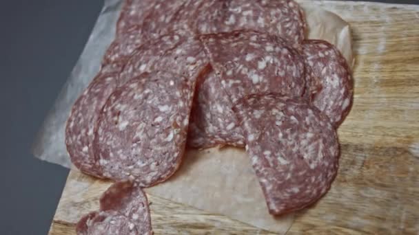 Fresh Italian sliced Salami sausage on a wooden cutting board, Heart shapes of Milano salami sausage. Preparing heart shaped pizza for Valentines Day for a loved one. 4K video - Footage, Video