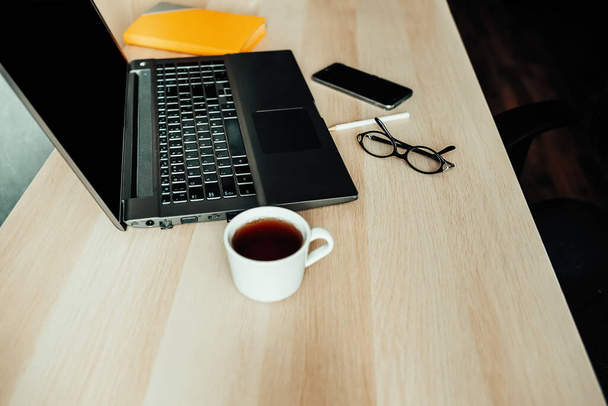 Laptop watch and cup on desktop - Zdjęcie, obraz