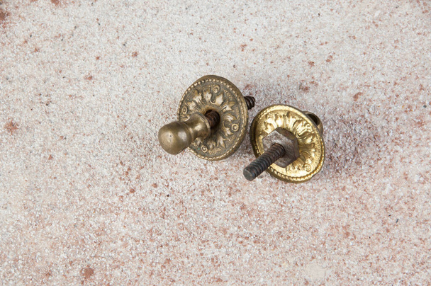 Vintage brass drawer pull knobs on concrete background. Copy space for text. - Photo, Image