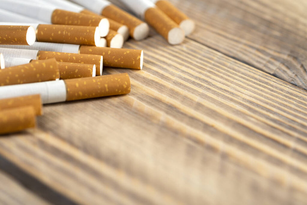cigarettes on wooden background, close-up of a cigarette with place for text. - Photo, image