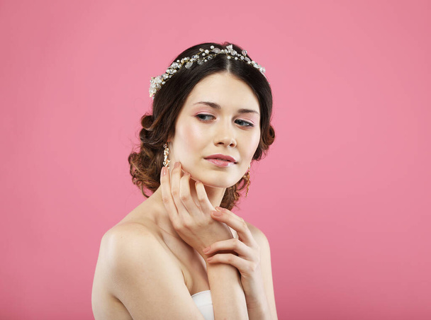 Fashionable young bride with gorgeous diadem. Studio portrait over pink background. Beautiful model with bridal makeup and hairstyle. - Zdjęcie, obraz