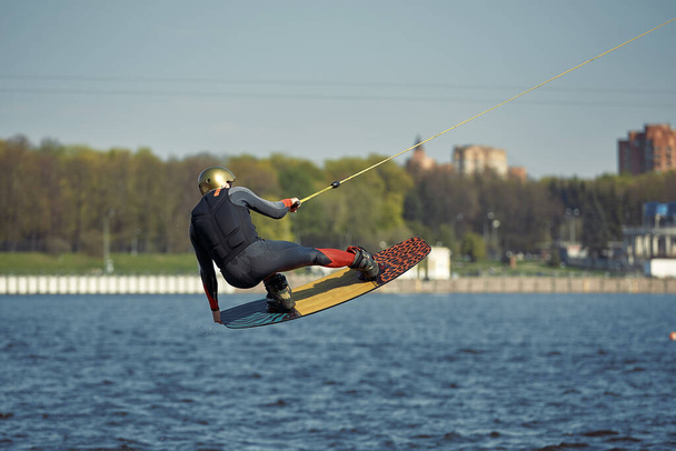 Young man riding wakeboard on a summer lake - Photo, Image