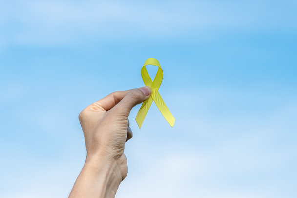 Suicide prevention, Sarcoma, bone, bladder, Childhood cancer Awareness month, Yellow Ribbon for supporting people living and illness. children Healthcare and World cancer day concept - Photo, Image