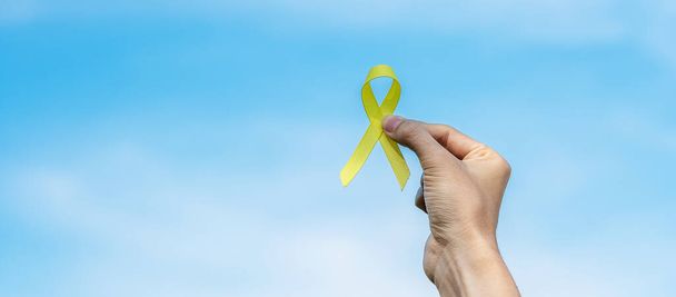 Suicide prevention, Sarcoma, bone, bladder, Childhood cancer Awareness month, Yellow Ribbon for supporting people living and illness. children Healthcare and World cancer day concept - Photo, Image