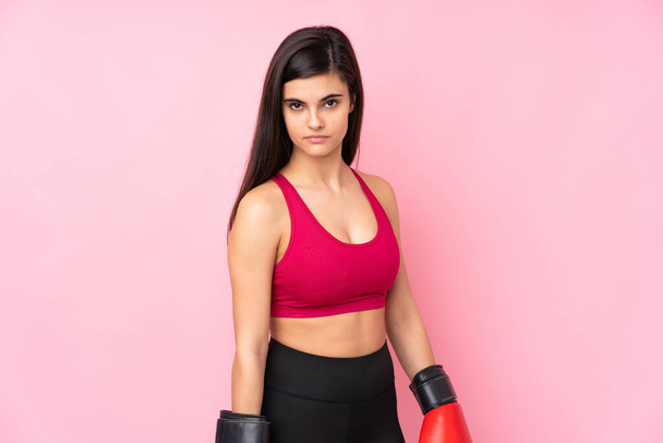 Young sport woman over isolated pink background with boxing gloves - Фото, зображення