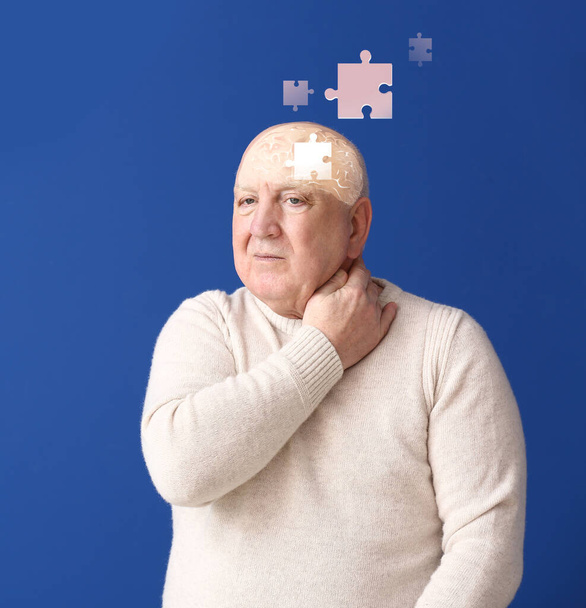 Älterer Mann mit geistiger Behinderung auf farbigem Hintergrund - Foto, Bild