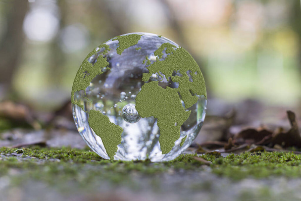 A closeup shot of a crystal ball with the map of the world - Photo, Image