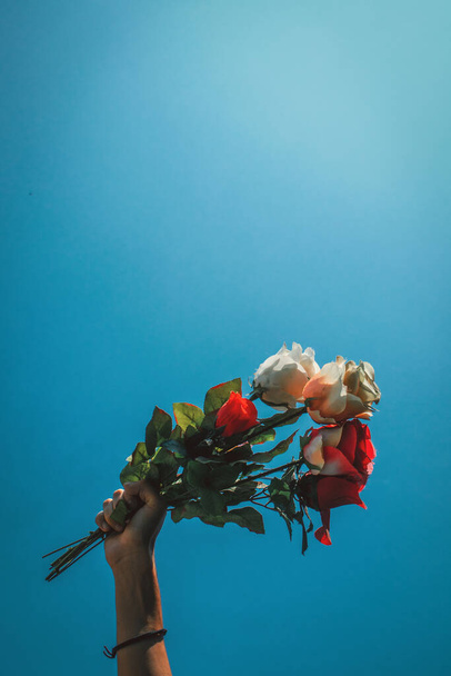 A vertical shot of a person holding a rose bouquet i - Photo, Image