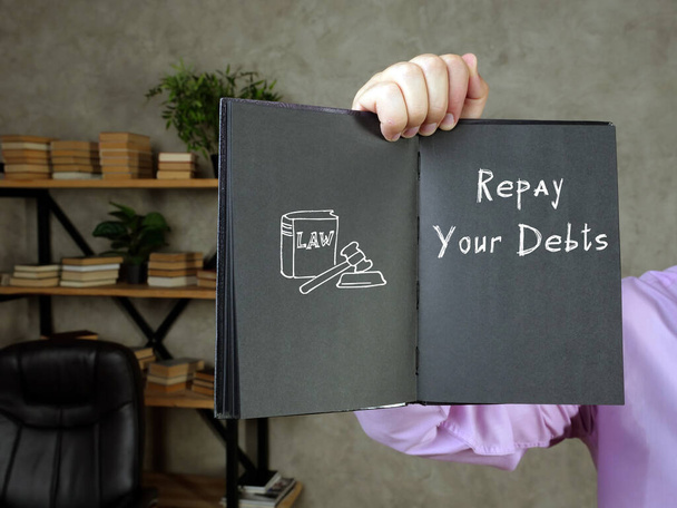  Conceito jurÃ dico sobre Reembolsar suas dívidas com sinal na folha - Foto, Imagem