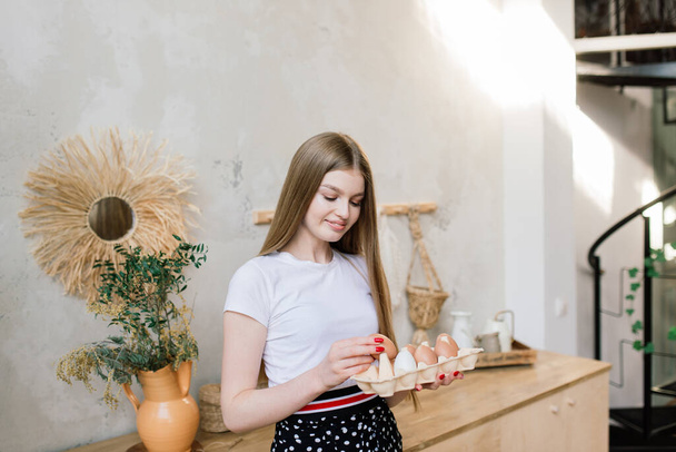 Healthy eating concept. Beautiful young woman with eggs at kitchen. - Fotografie, Obrázek