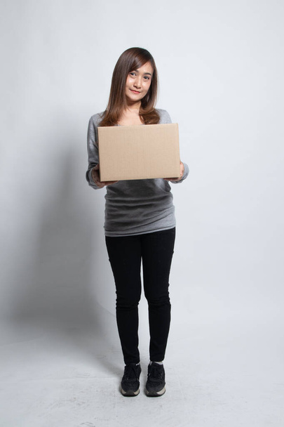 Delivery, relocation and unpacking.  young asian woman holding cardboard box on white background - Foto, Imagem