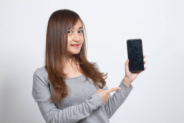 Young Asian woman point to mobile phone on white background - Fotografie, Obrázek