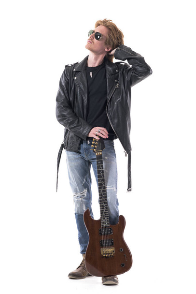 Handsome stylish rocker man looking up for music inspiration with hand in hair. Full body isolated on white background.  - Φωτογραφία, εικόνα