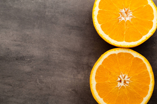 Orange slice on the grey  background. - Foto, imagen