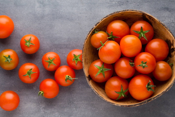 Tomato on the gray background. - Zdjęcie, obraz