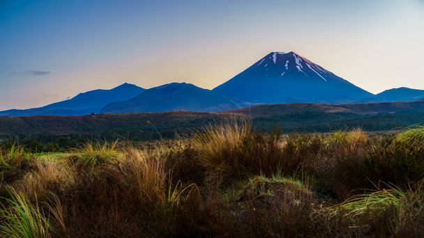 sunrise over cone volcano mount ngauruhoe in tongariro in new zealand - Fotó, kép