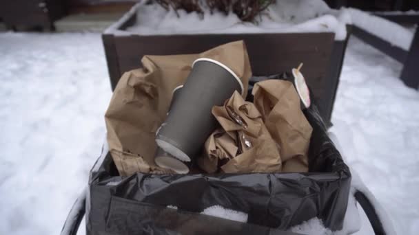 The used coffee cup and plastic straws are thrown into the trash, protection of nature, ecology - Footage, Video