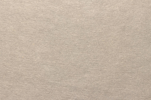 Light brown cardboard texture. Uniform beige background with small inclusions. - Φωτογραφία, εικόνα