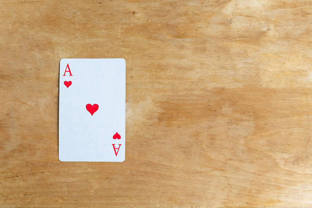 Ace of Hearts playing card on wooden background, top view, copy space - Foto, Imagem
