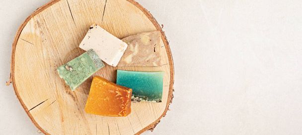 Eco friendly handmade organic soap bar on wooden background. Zero waste sustainable lifestyle. Self care concept. Banner, flatlay, top view - Photo, Image