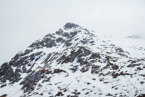 Montagne avec bonnet de neige. Le sommet de la montagne dans la neige sur le fond du ciel. - Photo, image