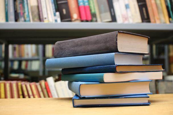 Stack of books on the table in library - Photo, Image
