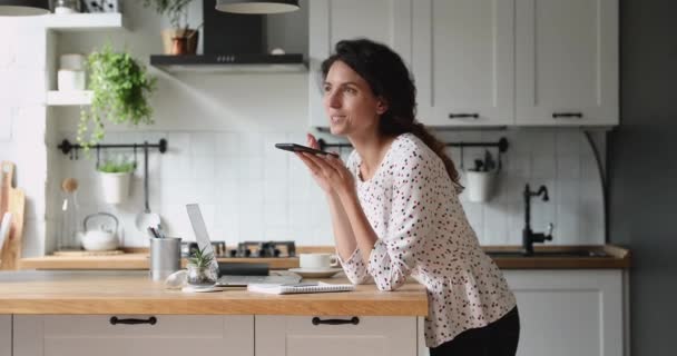 Millennial woman dictating audio message using smartphone app. - Filmmaterial, Video
