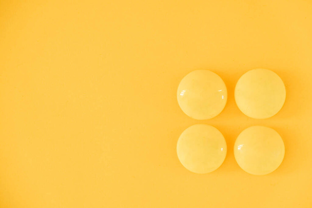 Yellow balls on yellow background. Minimal concept. Top view. Copy, empty space for text. - Foto, afbeelding
